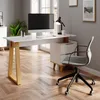 A modern home office setup with a white desk and wooden legs, a computer, a lamp, and a chair. Voir les images du produit