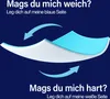 A diagram showing a mattress topper with two sides, one blue and one white, with arrows indicating how to flip it for different firmness levels. Text above and below explains the options. Produktbild-Vorschau