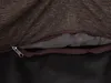 A close-up view of a zipper on a brown fabric item, revealing a gray interior. Anteprima dell’immagine prodotto