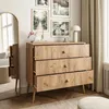 A dresser with three drawers is shown in a room with framed pictures on the wall and a large mirror. Náhľad obrázku produktu
