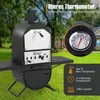 A black outdoor pizza oven is shown in a grassy yard with a house and trees in the background. Text overlays describe features. Produktbild-Vorschau