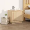 A bedside table with books and a small plant on it, next to a bed. Produktbild-Vorschau
