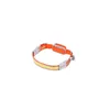 A headlamp with an orange band and a white LED strip. Náhľad obrázku produktu