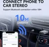 A close-up view of a car's interior, showing a phone connected to the car stereo via a Bluetooth adapter. Podgląd zdjęcia produktu