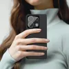 A person holds a smartphone with a camera lens protector applied. Produktbild-Vorschau