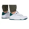 A person wearing Puma sneakers and green pants. Produktbild-Vorschau