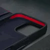 Close-up view of the interior of a dark blue leather iPhone case with red trim. Produktbild-Vorschau
