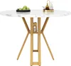 A round marble-patterned dining table with gold legs, set against a white background. Voir les images du produit