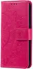 A pink flip phone case with a mandala pattern embossed on it. Produktbild-Vorschau