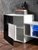 A modern TV cabinet with a black and white finish, featuring open shelves and a closed compartment. Produktbild-Vorschau