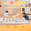 Two children playing on a wooden climbing structure indoors. Voir les images du produit