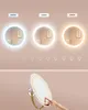A collage showing a lighted mirror with different light color temperatures and a close-up of a hand interacting with the mirror. Produktbild-Vorschau