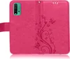 A pink flip case for a Xiaomi Redmi 9T phone, showing the exterior with a floral pattern and butterflies embossed on it. The phone is visible in the left section of the case. Produktbild-Vorschau