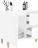 A white bathroom cabinet with wooden legs, shown from a slightly angled front view. The cabinet has a door on the left and open shelving with drawers on the right. Some towels are visible in a basket on the lower shelf. Náhľad obrázku produktu