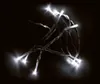 A string of white LED lights on a black background. Produktbild-Vorschau