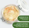 A close-up overhead view of a glass jar filled with fermented food, with its lid open. Produktbild-Vorschau