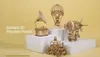 A collection of intricate 3D wooden puzzles, including a gramophone, a hot air balloon, a steampunk-style airship, and a carriage, displayed on white platforms against a yellow background. Podgląd zdjęcia produktu