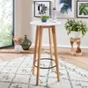 A round white bar table with wooden legs is shown in a room with a rug and decorative items. Produktbild-Vorschau