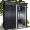A black metal garden shed with a sliding door, a shovel hanging inside, and some greenery around it. Anteprima dell’immagine prodotto
