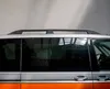 Side view of a silver and orange van with black roof rails and tinted windows. Podgląd zdjęcia produktu