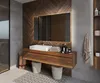 A modern bathroom with a wooden vanity, a white sink, and a large illuminated mirror. Produktbild-Vorschau