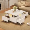 A modern white coffee table with drawers and LED lighting is placed in a living room setting next to a sofa. Podgląd zdjęcia produktu