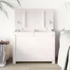 A white wooden storage chest with its lid open, placed next to a bed and a basket of laundry. Náhľad obrázku produktu