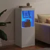 A white sideboard with blue LED lighting is placed in a living room next to a sofa and a plant. Anteprima dell’immagine prodotto