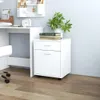 A white roll-front cabinet with two drawers and a plant on top, next to a white desk. Produktbild-Vorschau