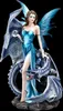 A figurine of a fairy with blue wings and a blue dress, holding a crystal ball, standing next to a blue dragon.