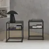 Two black metal bedside tables with shelves, one with a black mushroom-shaped lamp and books, the other with books and a glass object. Anteprima dell’immagine prodotto