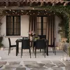 An outdoor patio dining set with a table and chairs under a pergola with string lights. Anteprima dell’immagine prodotto