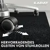 A close-up of an office chair wheel on a black floor mat, with arrows indicating smooth movement. Náhled obrázku produktu