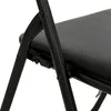 A close-up view of the black metal frame and seat of a folding chair. Voir les images du produit