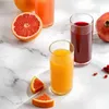 A still life of various juices and fruits on a marble surface. Produktbild-Vorschau