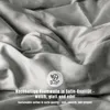 Close-up of rumpled grey fabric with a circular icon and text overlay. Produktbild-Vorschau