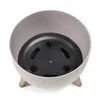 A top-down view of a planter pot with a black insert and wooden legs, isolated on a white background. Náhľad obrázku produktu