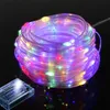 A coiled string of colorful LED lights with a battery pack. Produktbild-Vorschau