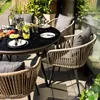 A dining set on a balcony with plants and a glass railing. Produktbild-Vorschau