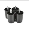 Four black plastic furniture feet with silver threaded bolts on a white background. Produktbild-Vorschau