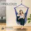 A woman sits in a colorful hanging chair indoors, with a couch visible in the background. Náhľad obrázku produktu