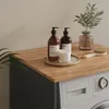 A close-up shot of a washing machine cabinet top with decorative items. Náhľad obrázku produktu