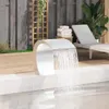 A modern outdoor pool area with a sleek waterfall feature, lounge chair, and wooden decking. Produktbild-Vorschau