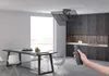 A modern kitchen and dining area with a TV mounted on the ceiling, controlled by a remote. Produktbild-Vorschau