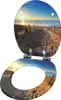 A toilet seat and lid decorated with a beach scene at sunset. Náhľad obrázku produktu