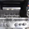 The interior of a gas grill, showing the burners and a heat shield. Produktbild-Vorschau