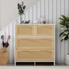 A modern dresser with rattan-effect drawers sits against a wall with vertical stripes. Umbrellas and a basket are on the left, and a plant is on the right. Náhled obrázku produktu