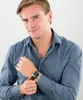 A man wearing a blue shirt and a watch. Voir les images du produit