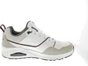 A side view of a white Skechers sneaker with gray and burgundy accents, isolated on a white background. Voir les images du produit