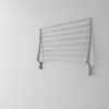 A silver and gray wall-mounted drying rack is shown against a white wall. Produktbild-Vorschau